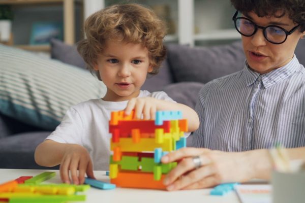 a man and a child playing with a building set